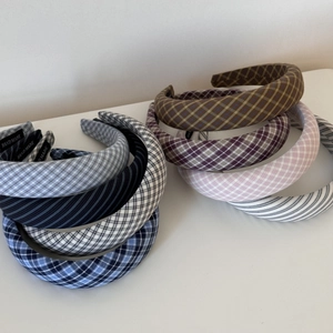 Detail showing handmade fabric headbands with vintage plaid and striped patterns
