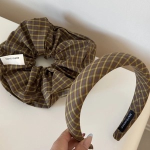 Close-up of sea salt blue checkered scrunchie and headband with hand made textile label
