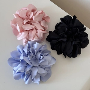 Three-piece set of large satin hydrangea floral hair scrunchies in pink, purple, and black