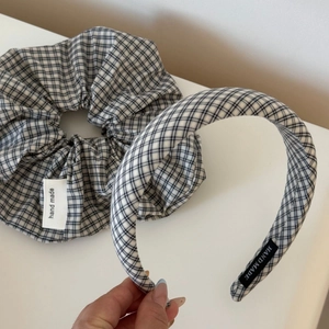 Detail of black and white checkered scrunchie and headband set with handmade labels