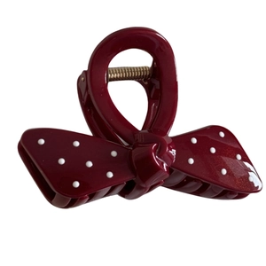 Elegant burgundy red bow hair claw clip with white polka dots and gold glitter finish