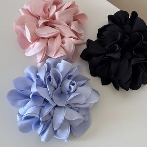 Three-piece set of large satin flower hair scrunchies in pink, black, and light blue colors
