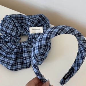 Detail of blue and white plaid scrunchie and headband set with handmade labels
