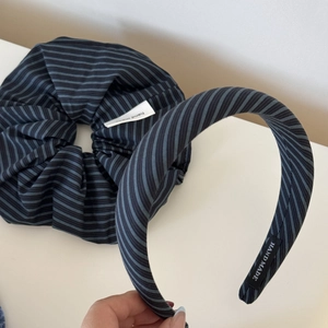 Detail of handmade striped hair scrunchie and headband set with sea salt blue and black tones