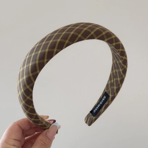 Detail of British plaid thick sponge headband with a handmade label and soft fabric texture