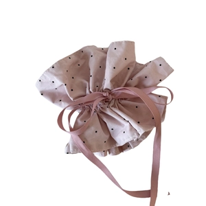 Pink drawstring storage bag with black polka dot print for cosmetics and gifts