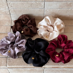Five-pack set of oversized satin hair scrunchies with elegant gold metal brand tags
