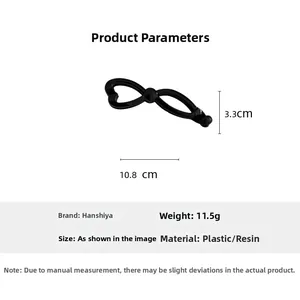 Macro shot detailing dimensions of black hollow bow banana clip, 10.8cm long