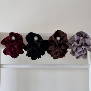 Detail of four large pleated satin scrunchies in wine red, black, coffee, and grey-purple