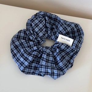 Detail showing blue plaid lace scrunchie with hand made woven label on cotton fabric