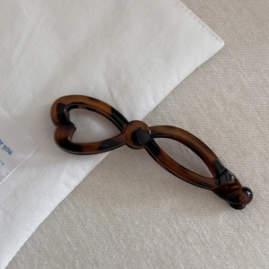Close-up of tortoise shell pattern banana hair clip with elegant hollow heart design