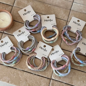 Close-up of Morandi color elastic hair band set with oval buckles on a white card
