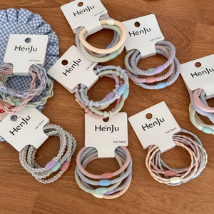 Colorful high-elastic hair band set on brand card over warm wood background