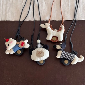 Detail of handmade fabric puppy and bear charm glasses holders with leather straps