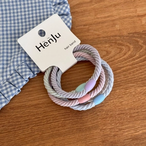 Close-up of pastel Morandi color elastic hair bands set on a white display card