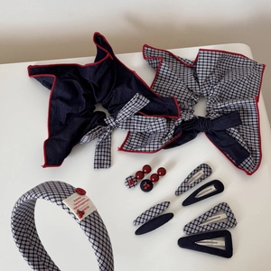 Flat lay detail of vintage navy plaid hair accessory set with scrunchies and headbands