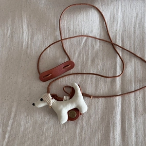 Detail of handmade cute puppy sunglasses holder necklace with brown leather lanyard
