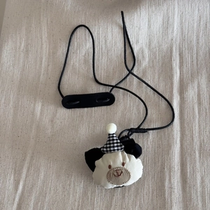 Close-up of cute bear glasses holder necklace with checkered hat and black lanyard