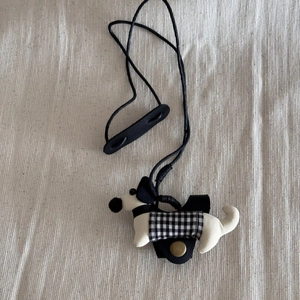 Detail of cute dachshund pendant necklace with black check dress and adjustable strap