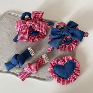Denim and red plaid hair clip set with heart bow designs in a retro handmade style