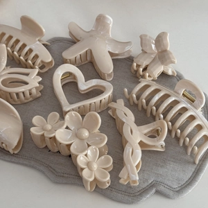 Creamy beige hair claw clip set with marble patterns in heart and flower shapes