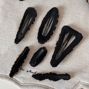 Detailed set of assorted leopard print hair clips with high-quality fabric texture