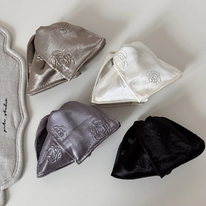 Detailed view of satin hair clips featuring 3D rose embroidery in four elegant colors