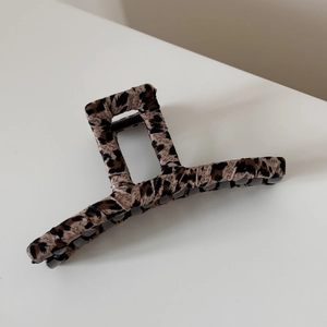 Detail view of large leopard print fabric shark hair clip with non-slip teeth grip