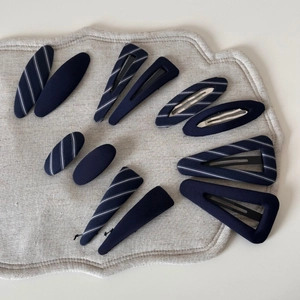 Set of navy blue and white striped fabric hair clips in oval and triangle shapes