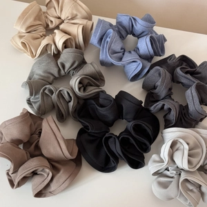 Close-up of 7 colors large fabric scrunchies with elastic texture and soft knit finish