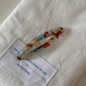 Detailed macro view of the marble pattern acetate hair clip with metal spring barrette