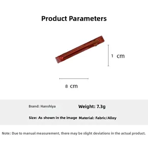 Detail view of red acetate hair clip measuring 8 cm in length with handmade engraving
