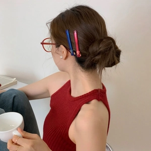Classic acetate hair clips in navy and burgundy shown on model for elegant side styling