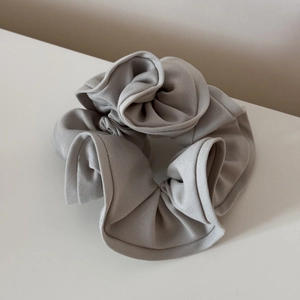 Close-up of light grey oversized scrunchie showing detailed ribbed knit texture
