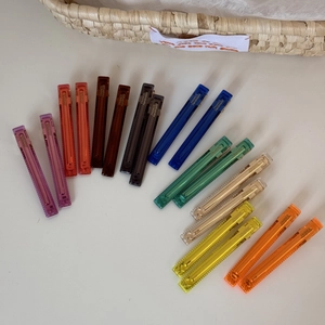 Detailed view of 18 acetate hair clips in 9 colors with France Handmade engraving