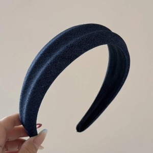Detail of dark blue denim headband showing textured twill fabric and non-slip black lining