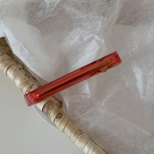 Detailed macro view of a red tortoiseshell acetate hair clip with gold France handmade logo