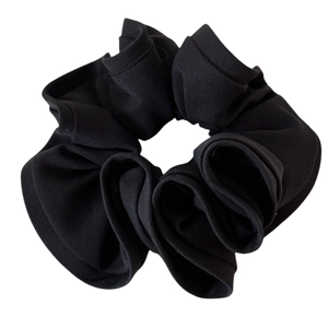 Minimalist solid black scrunchie with ribbed fabric texture and elastic hair band core