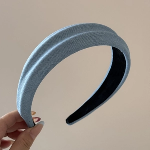 Close-up of light blue denim headband texture with non-slip black inner lining