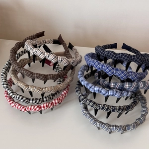 Detail of checkered fabric headbands with fine teeth for secure hairstyling in multi colors