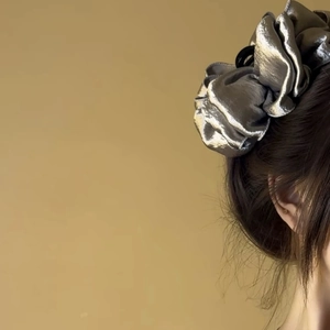 Close-up of metallic silver bubble cloud hair claw clip with pleated fabric texture