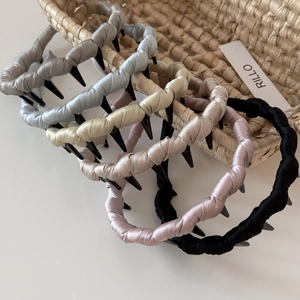 Detail showing various colors of satin fabric headbands with non-slip inner teeth