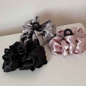 Close-up of cloud bubble hair claws in silver, pink, and black pleated metallic fabric