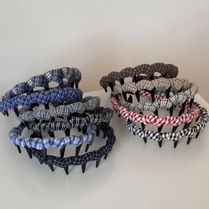 Close-up of checkered fabric headbands with inner grip teeth in various colors