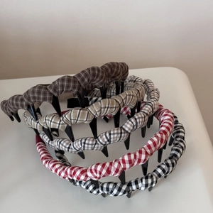 Detail showing five colors of plaid fabric headbands with non-slip inner teeth