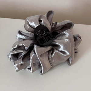 Detailed top view of a large silver grey velvet fabric hair claw clip with pleated design