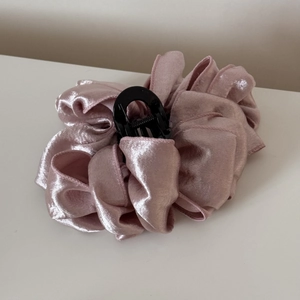 Detail of pink satin cloud bubble hair claw clip featuring layered ruched fabric texture