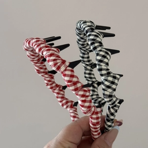 Close-up detail of checkered fabric texture on non-slip wave hairband with woven twist design