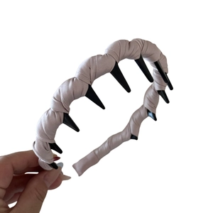 Pink satin fabric wavy headband with inner comb teeth for hair fixing on white background
