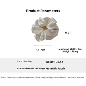 Detail view of cream white satin scrunchie showing 16cm diameter and silk glossy texture